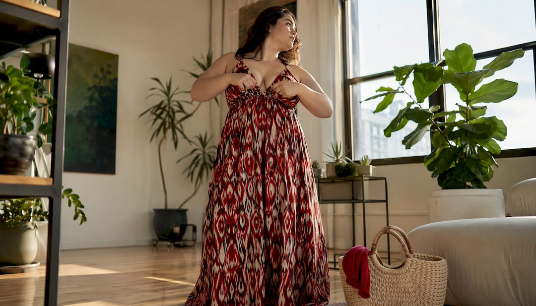 Woman in empire waist maxi dress adjusting fabric