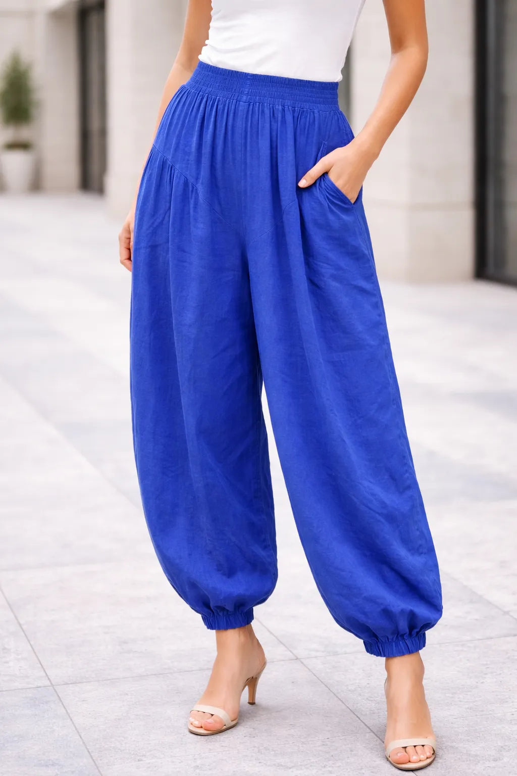 Royal Blue wide-leg pants worn by a person on a light gray pavement background