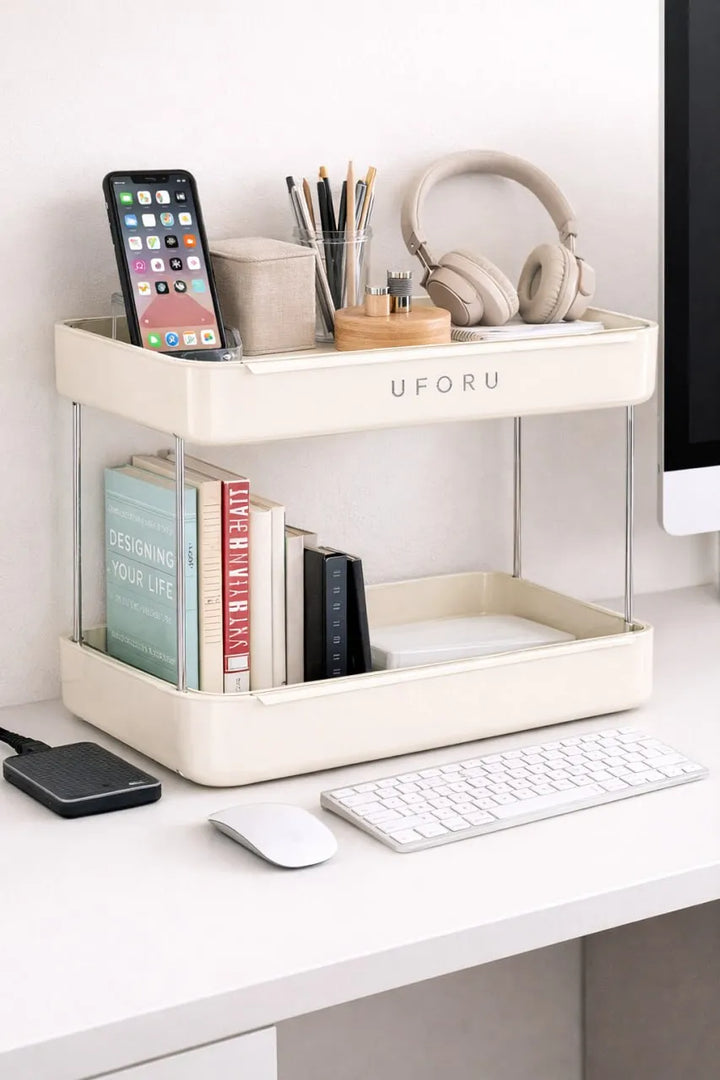 White desk organizer with books, phone, mug, and other items on a white desk.