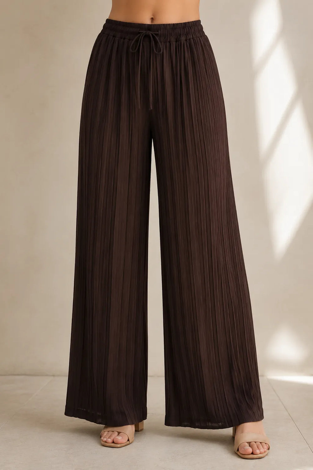Brown wide-leg pants on a neutral background