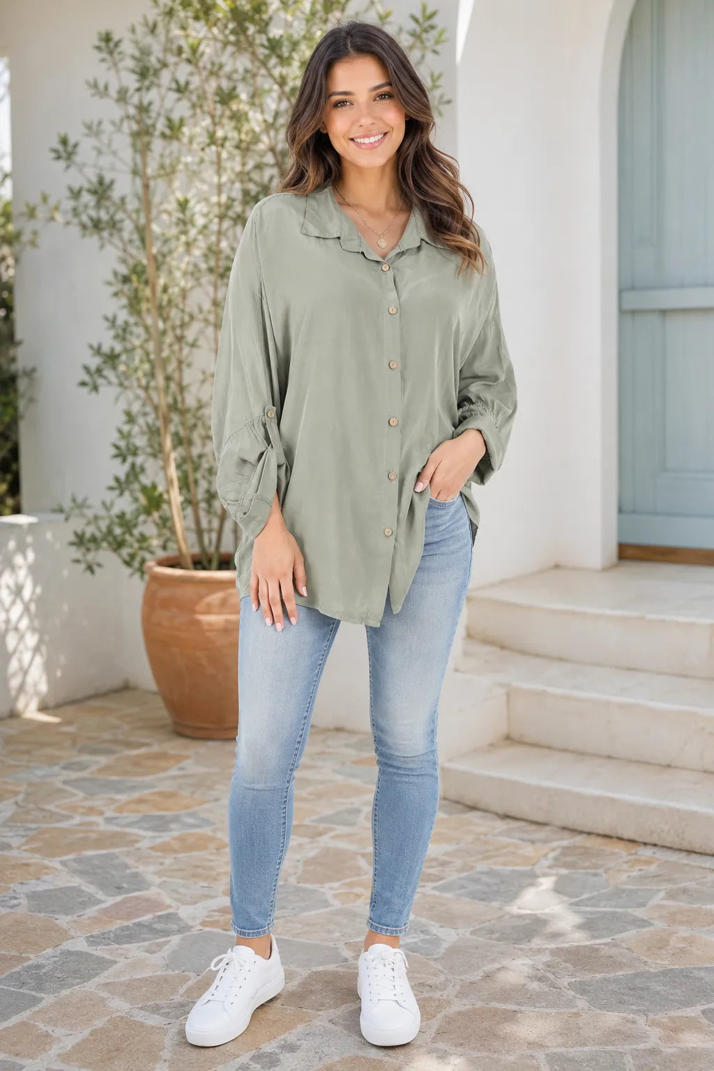 Model wearing a khaki silk-touch relaxed shirt with adjustable roll-tab sleeves