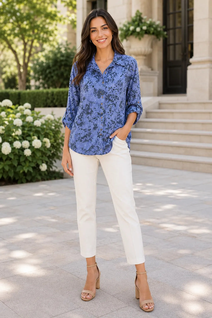 Model wearing a denim blue floral oversized shirt with a classic collar